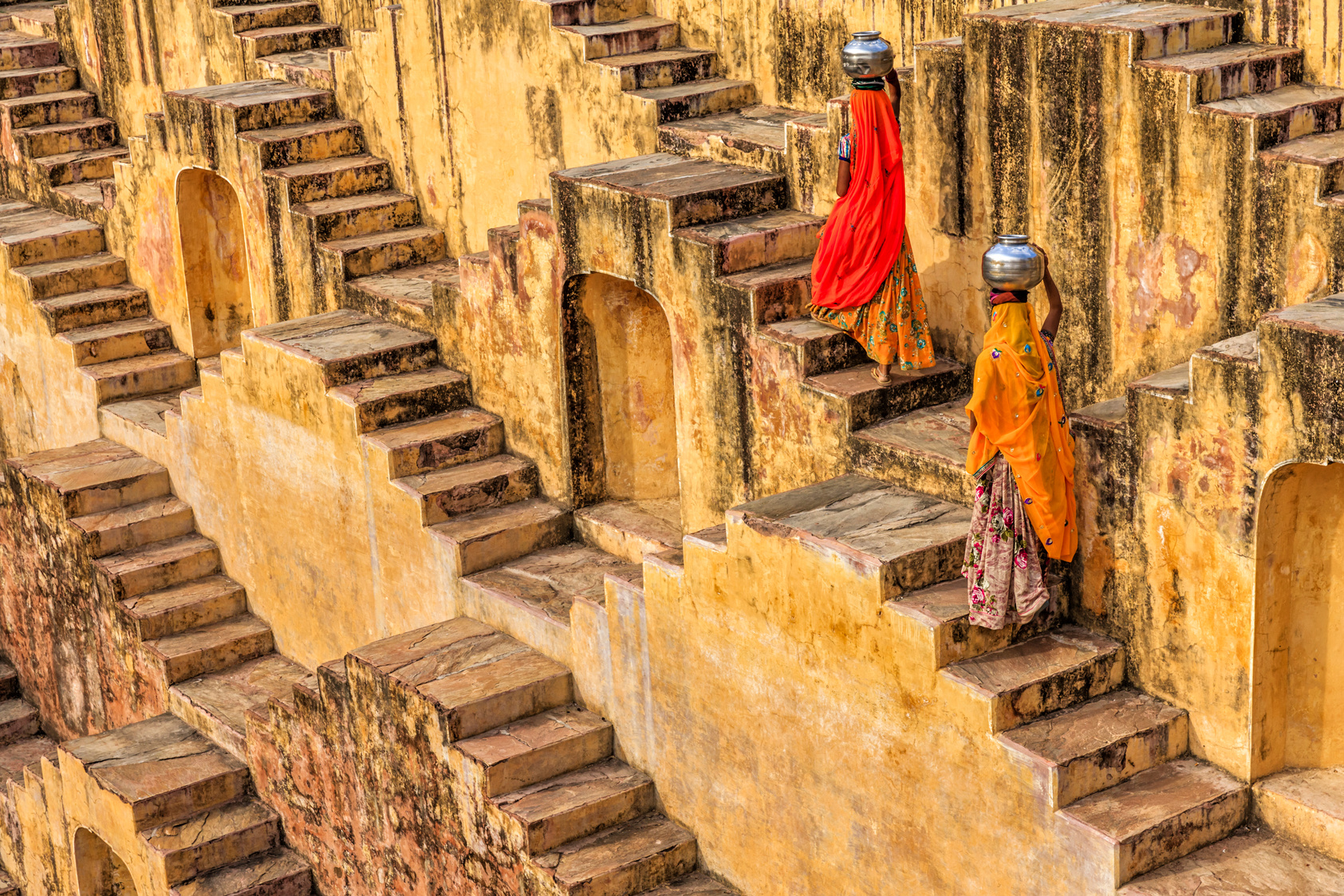 Indian women carrying water from stepwell near Jaipur